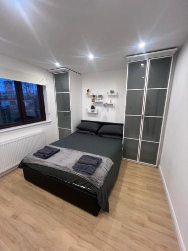 a bedroom with a large bed and a window at Shoreditch Dream in London