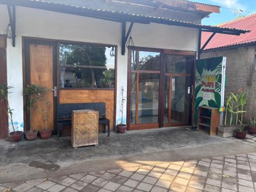 a store front with a bench and glass doors at Sony massage in Gili Trawangan