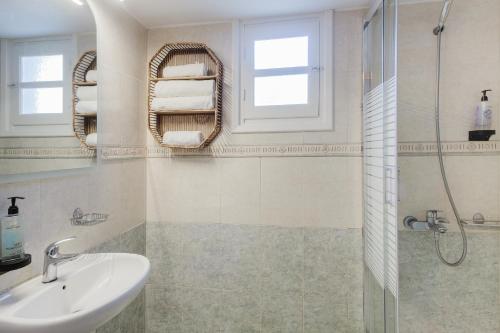 a bathroom with a sink and a shower at Pleiades Apartments in Lefkos Karpathou