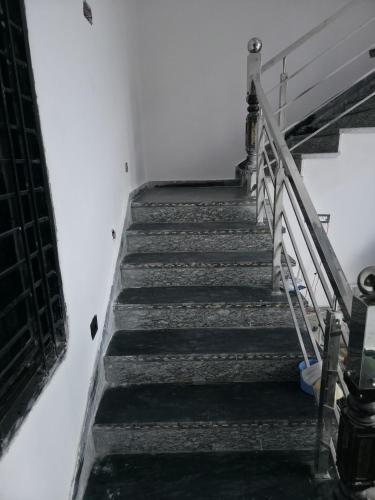 a stairway in a building with a bunch of stairs at Red diamond palace in Sīkar