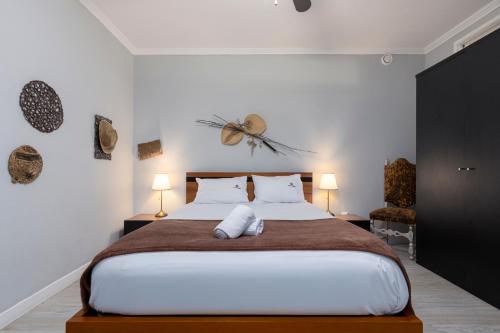 a bedroom with a large bed and two lamps at MyRiverPlace River View Porto apartments in Vila Nova de Gaia