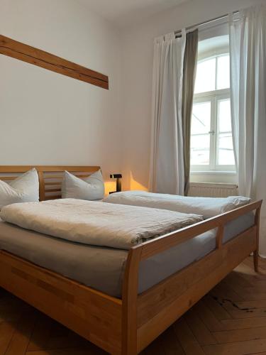 a bed in a bedroom with a large window at Haus mit Geschichte in Mähring in Mähring