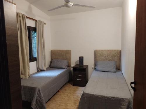 a bedroom with two beds and a window at Las Toribias II in El Rincón