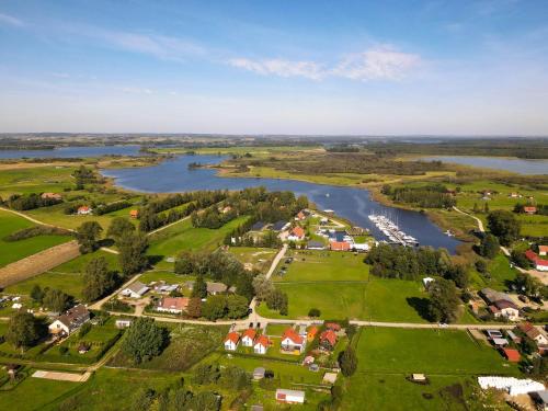 an aerial view of a village next to a river at Domki Górkło in Górkło