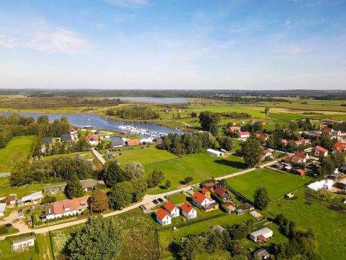 an aerial view of a small village next to a river at Domki Górkło in Górkło