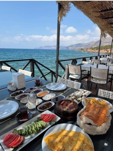 a table with plates of food on top of the ocean at Lamoya Suites in Silifke
