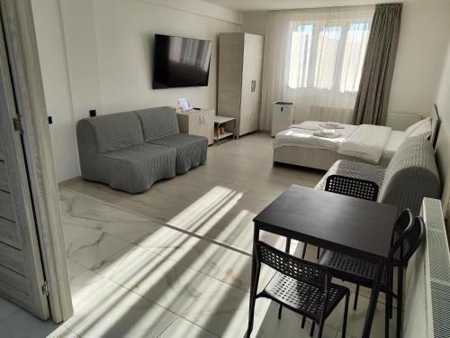 a living room with a couch and a bed at Max Night Dreams in Bucharest