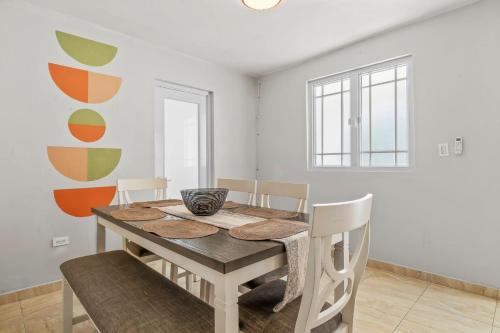 a dining room with a wooden table and chairs at Comfortable Home for 6 Near Airport & Beaches in Carolina