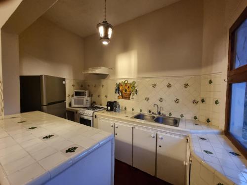 a kitchen with a sink and a stove at Hacienda de las Flores in San Miguel de Allende
