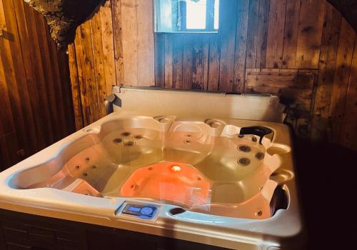 a bath tub sitting in a bathroom with at Chalet Lucien, Jacuzzi, Les 3 Vallées in Villarly