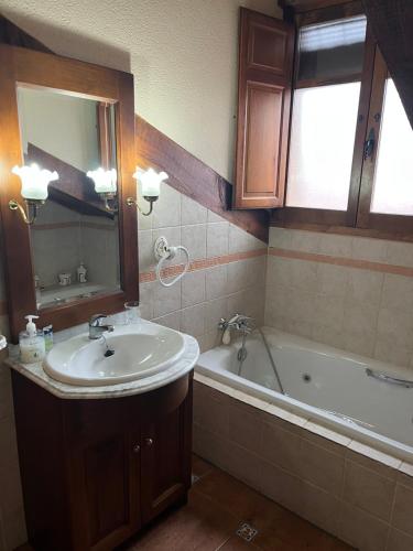 a bathroom with a sink and a bath tub at Casa del Herrador II in Carrascal del Río