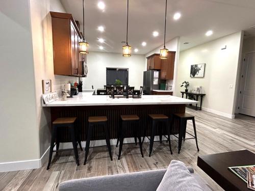 a kitchen with a large island with bar stools at Desert retreat 3BR close to River and Casinos in Bullhead City