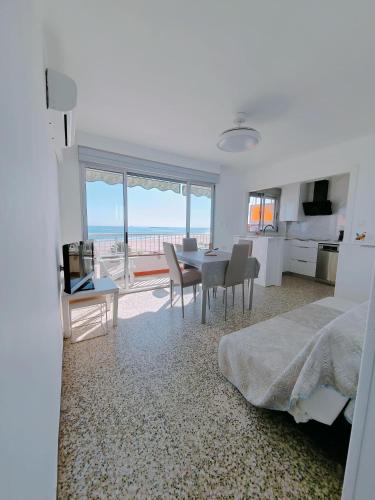a bedroom with a bed and a table and chairs at Vistal Mar in Puerto de Sagunto