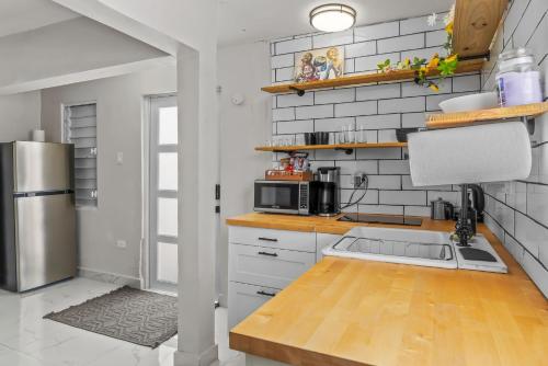 a kitchen with a sink and a refrigerator at Perfect Group Retreat for 10 Near Beach & Airport in Carolina