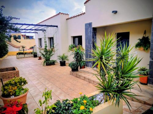 a courtyard with potted plants and a building at House with a heated pool for your exclusive use in Santa Brígida