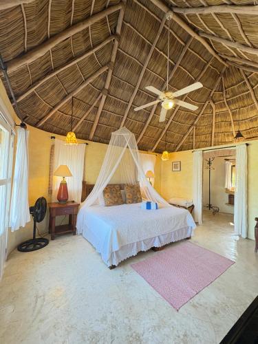 a bedroom with a bed with a mosquito net at Tia Adriana in Sayulita