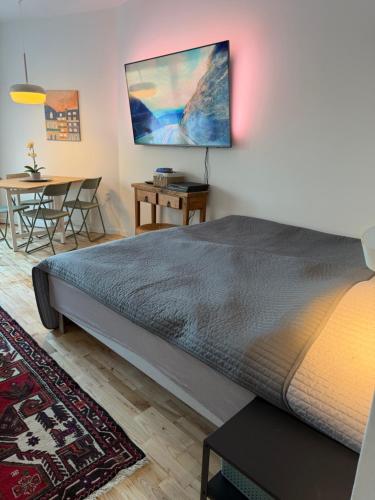 a bedroom with a large bed and a table at Balcony Apartment - Lyngby Great Copenhagen in Kongens Lyngby