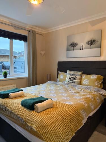 a bedroom with a bed with two pillows and a window at Stunning 2 Bedroom Bungalow - Free Parking - Convenient Location in Cox Green
