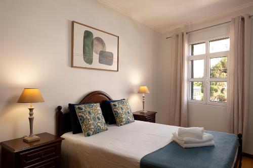 a bedroom with a bed and a window at Solful at the Nomads Village Ponta do Sol in Ponta do Sol