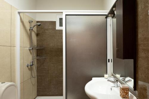 a bathroom with a sink and a shower and a toilet at Solful at the Nomads Village Ponta do Sol in Ponta do Sol