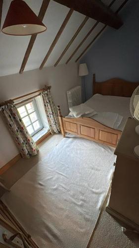 a bedroom with a bed and a window at La Merlerie in Malicorne