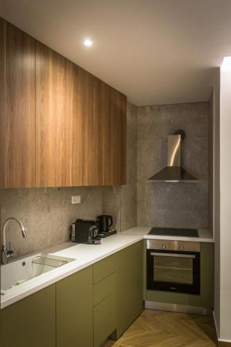 a kitchen with a sink and a stove top oven at City Breeze Suites in Heraklio