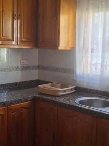 a kitchen with a counter top with a sink and a counter at Dos Hermanas in Sahagún