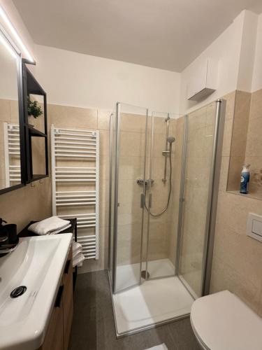 a bathroom with a shower and a sink at LakeCity Apartment in Klagenfurt