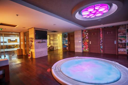 a room with a large tub in the middle of a room at CPAnkara Hotel in Ankara