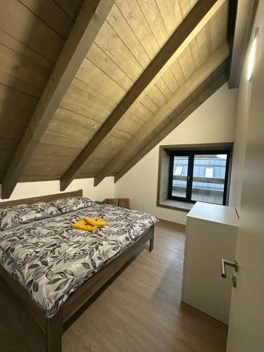 a bedroom with a bed in an attic at Apartmán Vališka in Horní Bečva