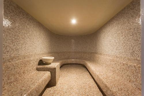 a room with a bathtub with a bowl on it at CPAnkara Hotel in Ankara