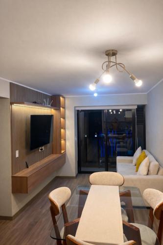 a living room with a couch and a tv at La Foret in Lima