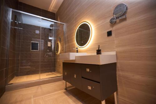 a bathroom with a sink and a shower at Bourdillon Hotel and apartments in Gwarinpa