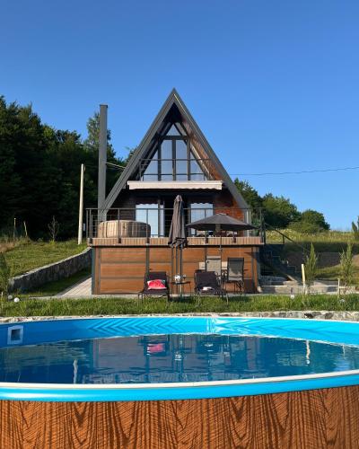 a house with a swimming pool in front of it at Villa Monteverde Goč in Stanišinci