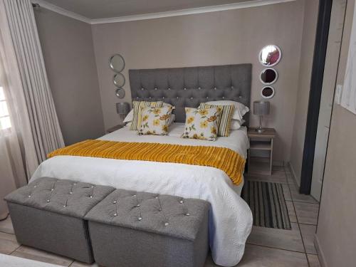 a bedroom with a large bed and a bench at Kaleb Guesthouse in Bethlehem