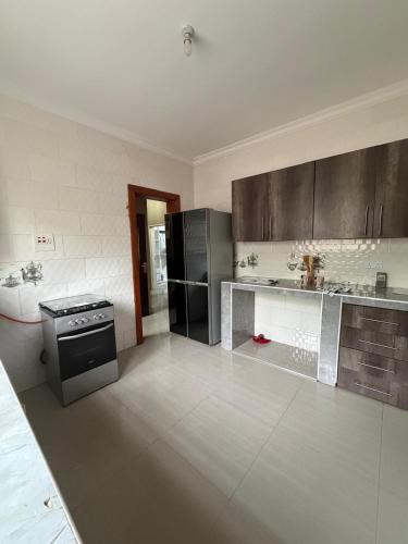 a kitchen with stainless steel appliances and a stove at Edmut Apartments in Lusaka