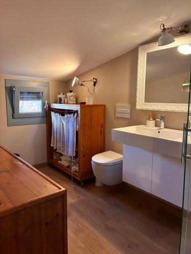 a bathroom with a sink and a toilet and a mirror at PassiveRooms in Vilanova i la Geltrú