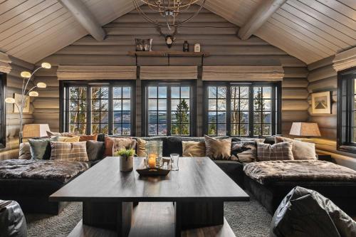 a living room with a couch and a table at TH590- Large ski-in out chalet with jacuzzi, sauna in Trysil in Trysil