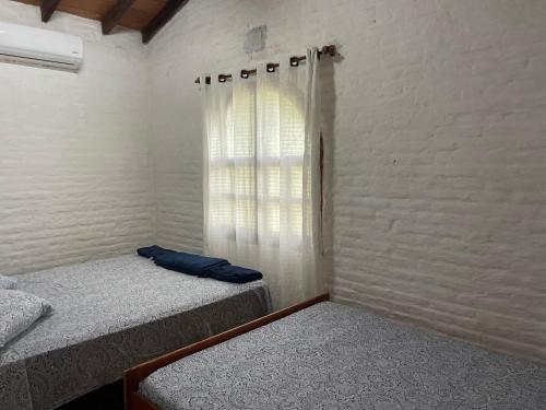 Llit o llits en una habitació de Guaviyu Emprendimiento