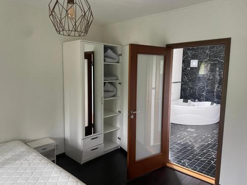 a bathroom with a sink and a mirror and a tub at Коттедж in Lappeenranta