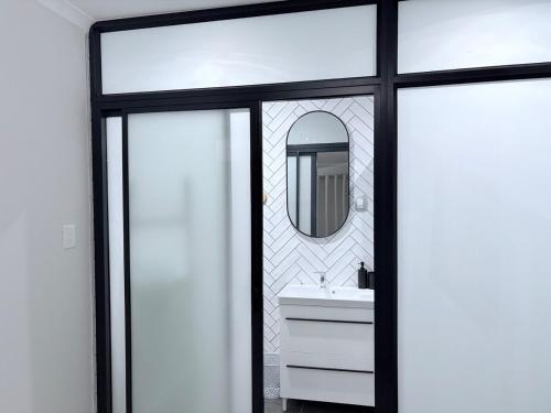 a bathroom with a sink and a mirror at Canopy stay 4 in Sandton
