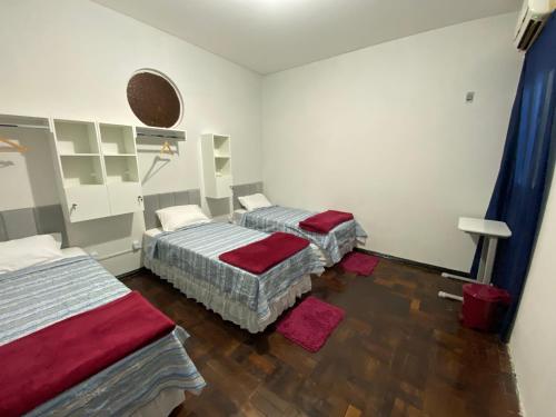 a room with two beds in a room at Açaizeiro Hostel in Belém