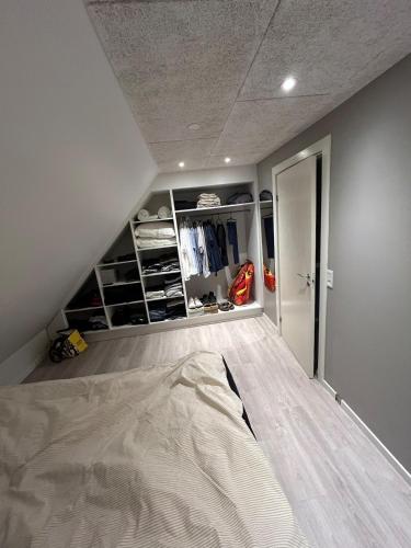an attic room with a bed and a closet at Grønningen Retreat in Billund