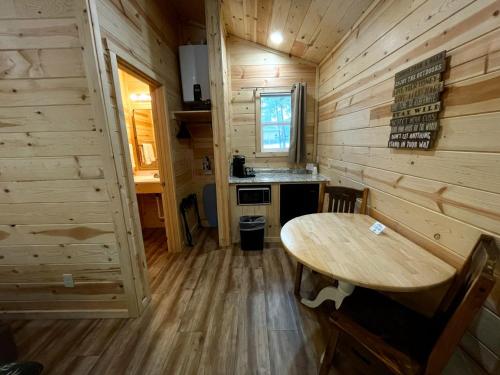 a wooden cabin with a wooden table in a room at Riverfront Motel & Cabins in Thompson Falls