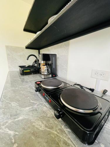 a kitchen with a black stove top in a kitchen at CASA HARPIA Apartamentos Studio in Pedasí Town