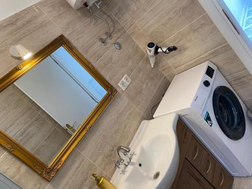 a bathroom with a mirror and a sink at Apartments Villa ALEN in Mimice