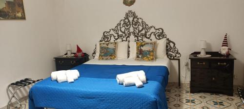 a bedroom with a blue bed with towels on it at Sun Terrace Sorrento in Sorrento