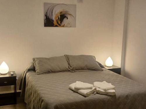 a bedroom with a bed with two towels on it at Dpto Amoblado in Villa María