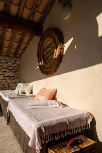 a bedroom with two beds and a mirror on the wall at Mas Oréa côté piscine in Gordes