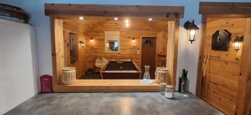 a large wooden room with a pool table in it at Les Grosses Pierres à Spa in Spa